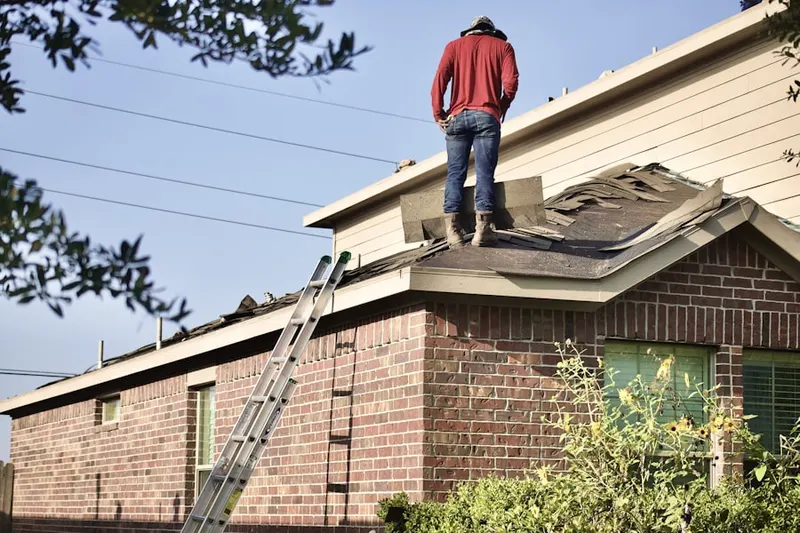 Professional roofer working on a residential roof in Interlaken Estates
